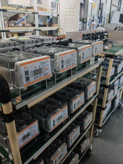 A production line of ALT Series chargers ready to ship into the rental network's depot footprint.