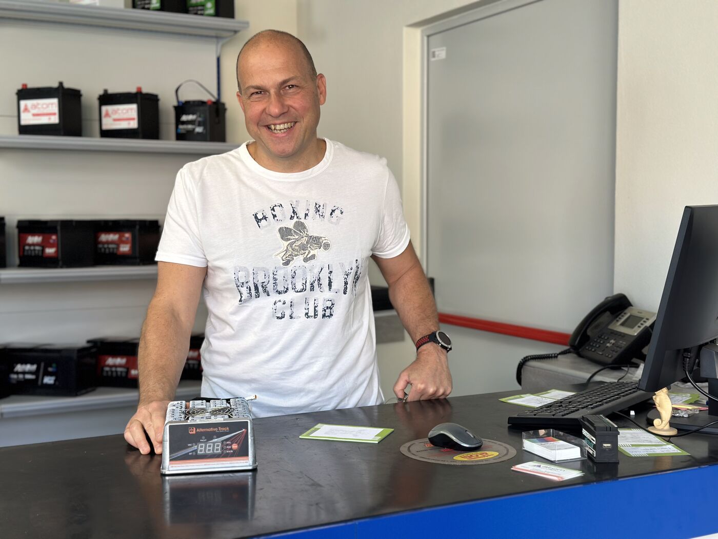 Distributor partner with an ALT charger at the showroom desk