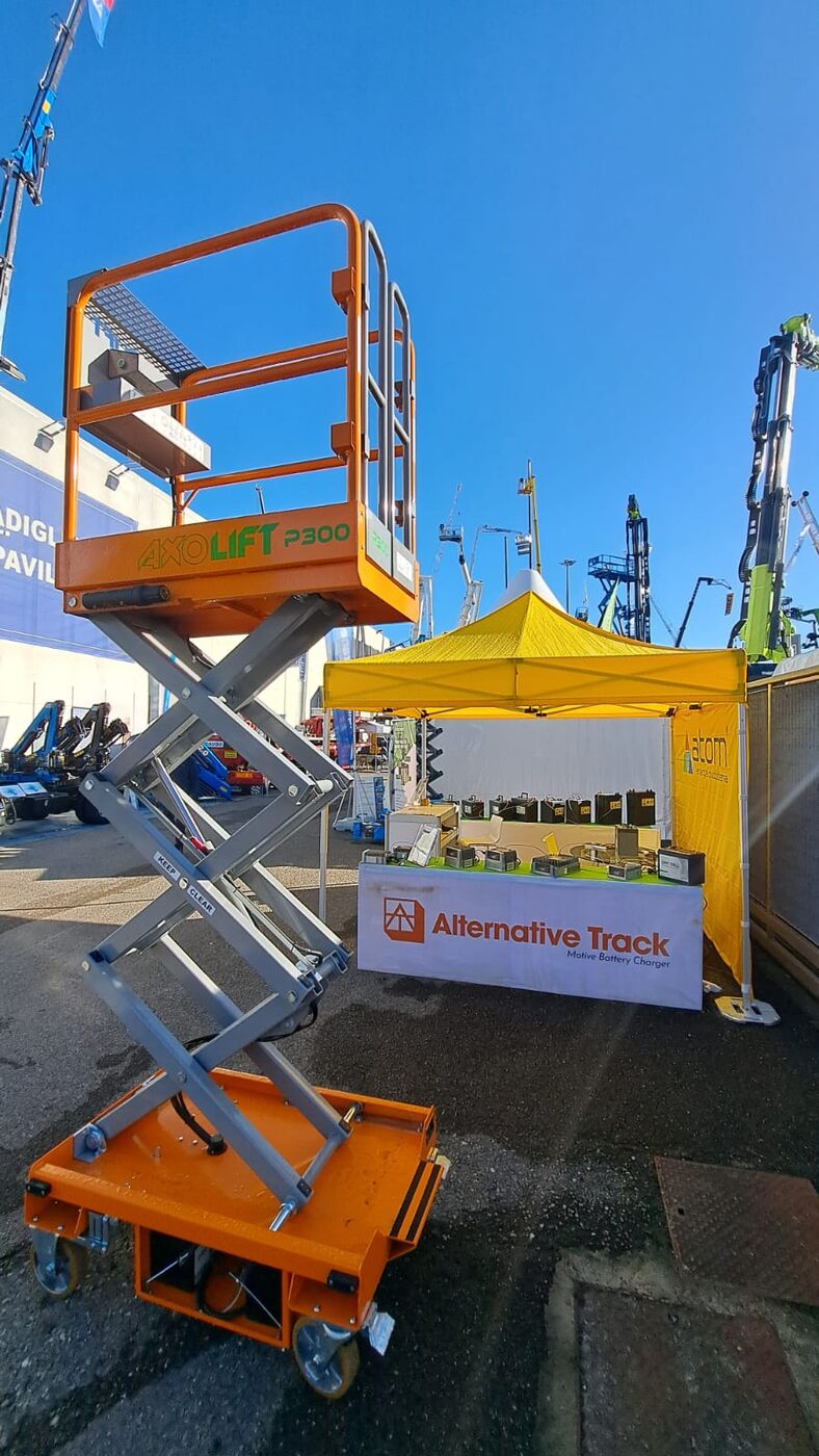 Scissor lift in the open with Alternative Track booth
